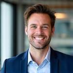 Portrait souriant de Marc Dubois, expert en investissement boursier.